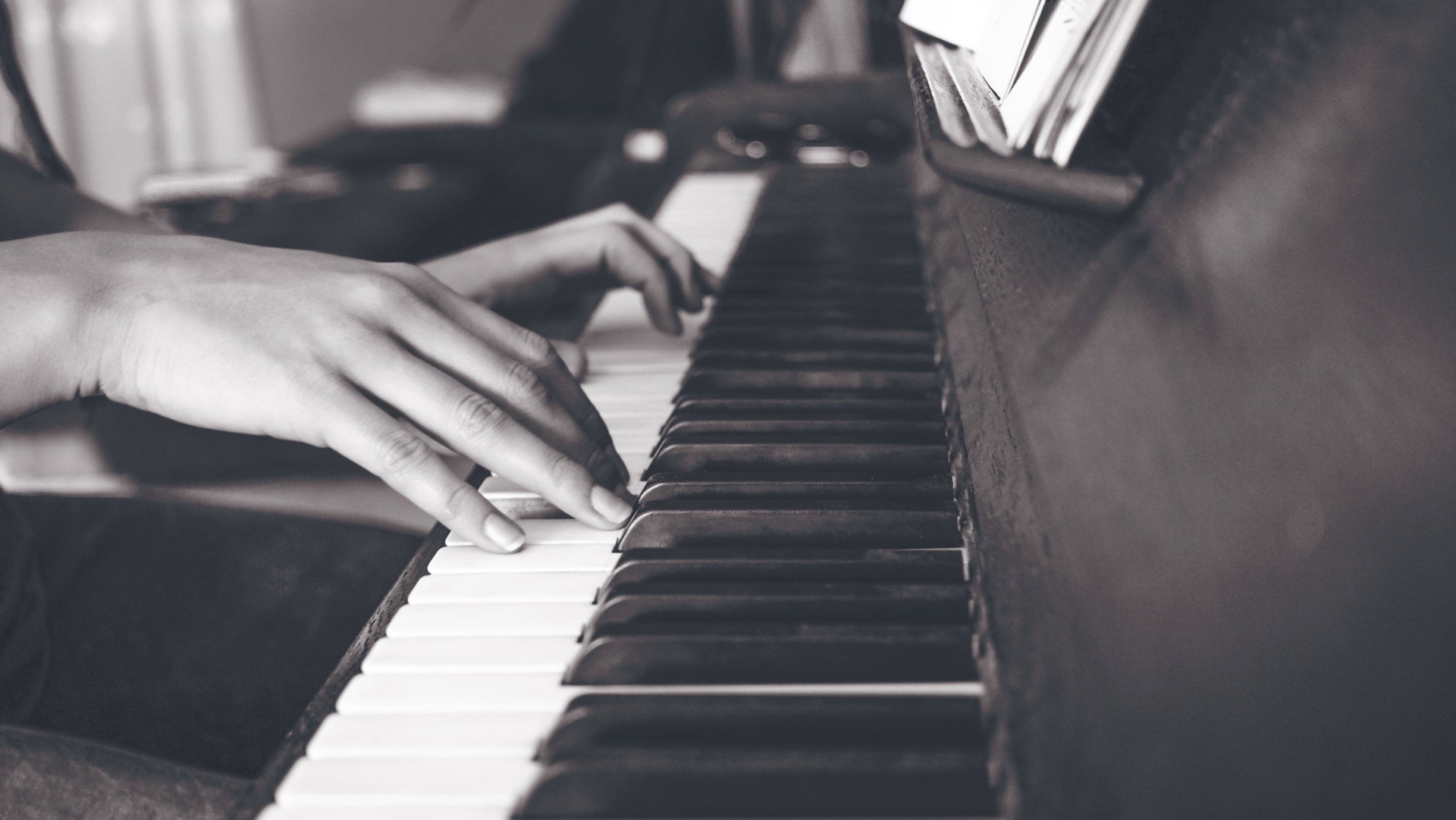 Hands on a piano keyboard